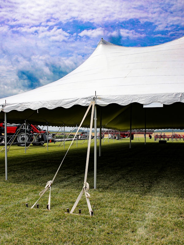 Large white tent set up for a backyard celebration