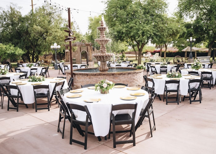Rows of tables and chairs arranged for a party